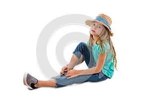Solemn thoughtful little girl sitting on ground photo