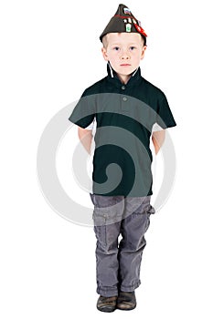 Solemn young blonde boy front on wearing green shirt and Russian Vintage army hat - pilotka