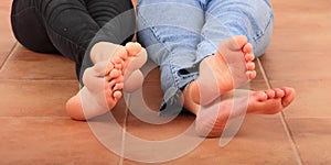 Soles of bare feet of teenage girls photo