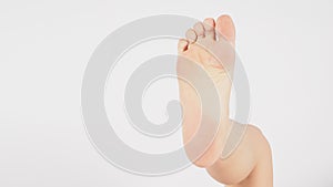 Soles of the feet and barefoot and legs of Asian Male is isolated on white background