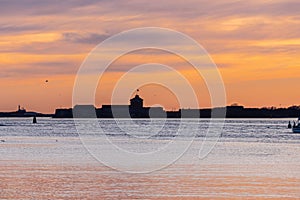 Solhouette of an old coastal fort at sunset