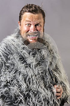 Solid bearded man in a fur mantle studio emotional