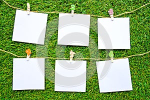 Solid color notes, isolated on artificial grass background