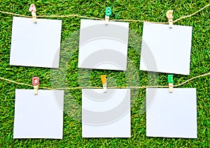 Solid color notes, isolated on artificial grass background