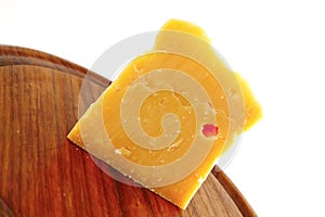 Solid gauda cheese on wood