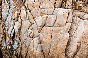 Solid limestone rock texture with muliple cracks