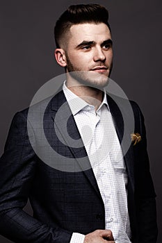 Solid man with beard and mustache in classic fashionable suit.