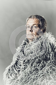 Solid middle-aged man in a fur mantle