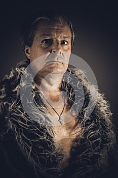 Solid middle-aged man in a fur mantle