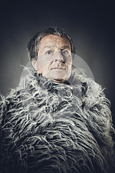 Solid middle-aged man in a fur mantle