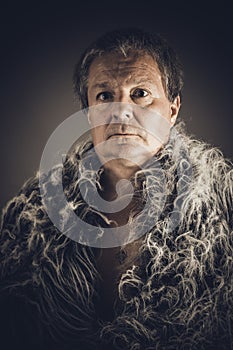Solid middle-aged man in a fur mantle