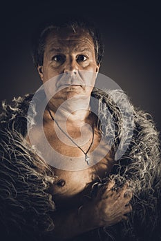 Solid middle-aged man in a fur mantle