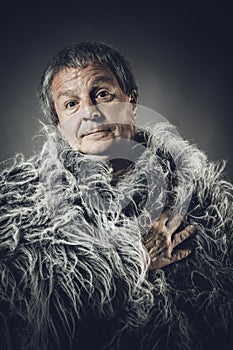 Solid middle-aged man in a fur mantle