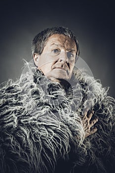 Solid middle-aged man in a fur mantle