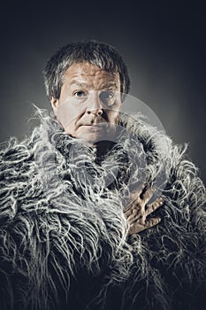 Solid middle-aged man in a fur mantle