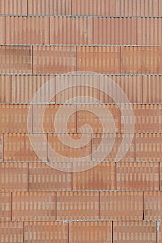 Solid red brick wall of a house under construction