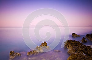 Solid rocks and a beautiful ocean at dusk