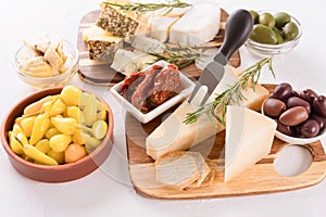 Solid and soft-ripened cheeses served with olives, pickled baby peppers, sun dried tomatoes and artichokes