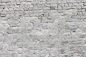 Solid wall with white bricks in vintage style as grey stonewall background or wallpaper with urban house architecture seamless age