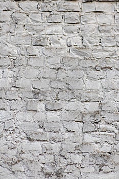 Solid wall with white bricks in vintage style as grey stonewall background or wallpaper with urban house architecture seamless age