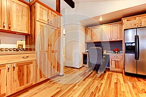 Solid wood birch kitchen custom made cabinets with hardwood floor.