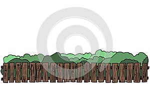 Solid wooden fence on the background of the garden and shrubs.