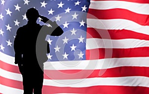 Solider Saluting Against The American Flag photo