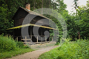 A solitary closed wooden house by the trail