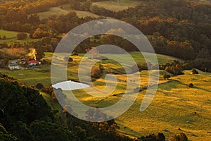 Countryside solitary farm with pond by sunset photo