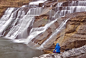 Solitary figure next to Ithaca Falls in rural New York