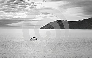 Solitary Fishing Boat at Dusk Near Coastal Mountain, Catalonia