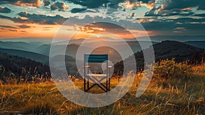 Solitary folding chair facing a stunning mountain sunset