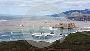 Solitary paraglider & the vast ocean