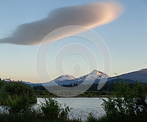 Solitary pink cloud over The Sisters