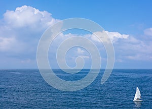 Solitary sailboat in waters of the sea