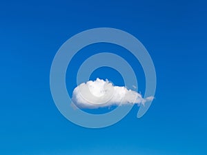 Solitary white cloud in blue sky