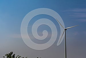 Solitary Wind Turbine on blue sky background