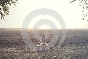 Solitary woman relaxes sitting in the middle of nature