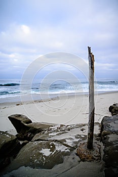 Solitary wooden post beach in San Diego