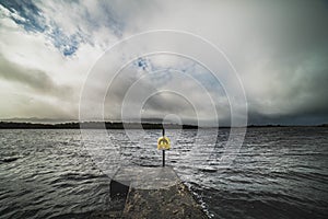 Solitude and helplessness: a ring buoy standig alone by Lough Melvin, Ireland evokes despair, safeness, isolation and solitude