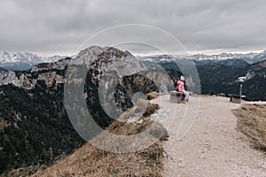 Solitude and Serenity: Girl on Mountain Path with Telescope in Central European Landscape