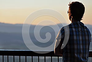 Solitude - Young man gazing over mountains