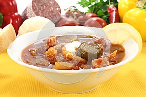 Soljanka in a soup bowl with pickles
