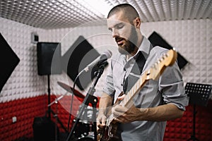 Solo adult guitarist singing while playing guitar