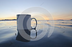 A solo blank coffee mug floating in the water