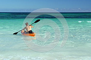 Solo canoeist paddling in sea