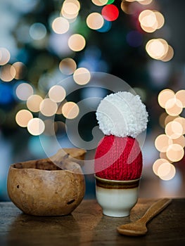 Solo Elegance: A Cozy Christmas Egg in Santa\'s Embrace amid Glittering Tree Lights