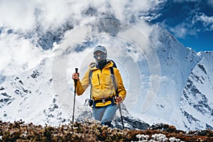 Solo hiker traveling among altitude cloudy mountains