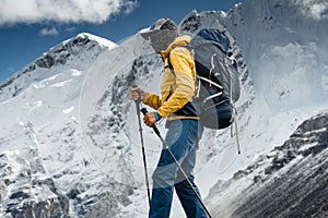 Solo hiker traveling among altitude cloudy mountains