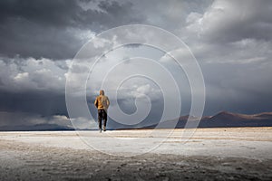 Solo man walking on the Bolivian salt flats in Uyuni